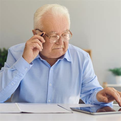 Imagen de un adulto mayor utilizando una tablet con software de comunicación asistida.