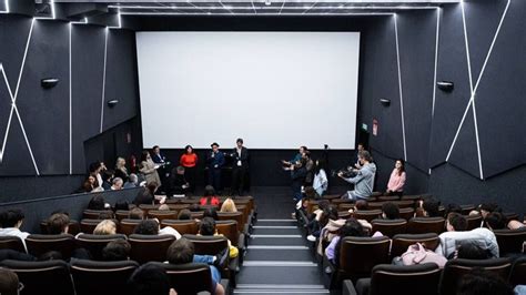 Estudiantes observando una proyección en un cine club escolar