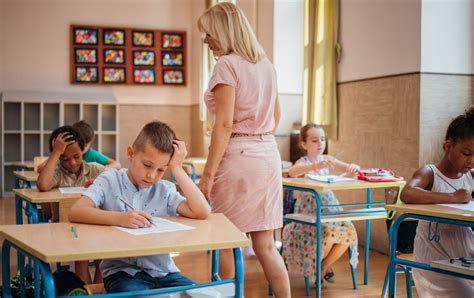 Docente en el aula despidiéndose de sus alumnos