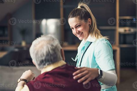 Foto de médico geriátrico visitando a un adulto mayor en su hogar