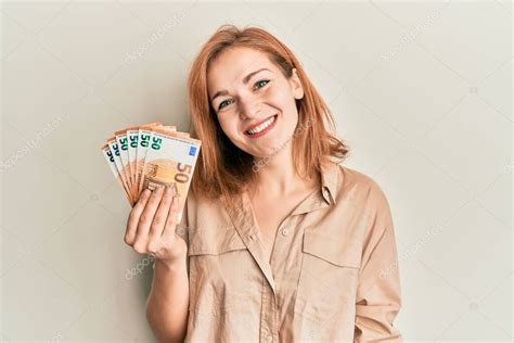 Fotografía joven mostrando billetes dentro de celda-habitación