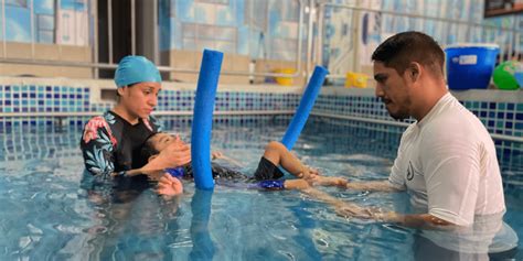Imagen de niños con discapacidad disfrutando de una sesión de terapia acuática, mostrando sonrisas y participación activa.