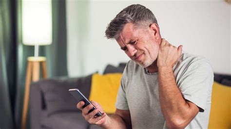 Persona mayor con dolor de cuello, señalando la zona cervical