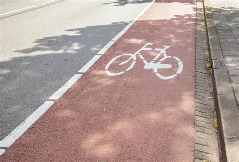 Detalle de demarcación de cruce peatonal sobre ciclovía, con señalética de advertencia para ciclistas.