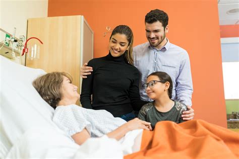 Equipo de profesionales de cuidados paliativos brindando atención a un paciente y su familia