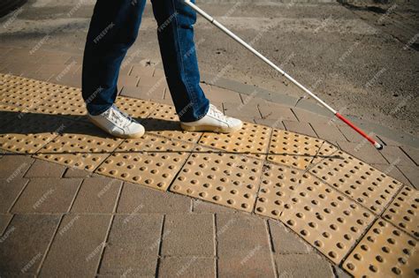 persona con bastón blanco navegando por la ciudad