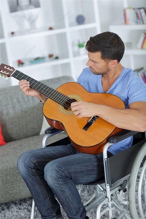 Foto de Eric Howk tocando la guitarra en silla de ruedas