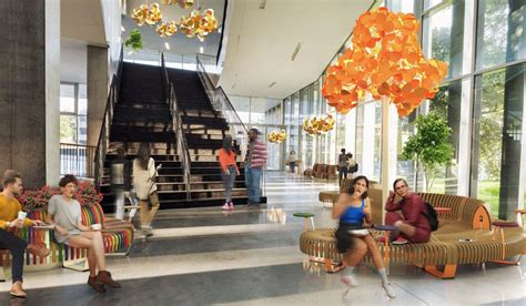 Diseño de interiores de un evento inclusivo utilizando mobiliario y paneles modulares de cartón, con personas interactuando