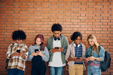 Foto de adolescentes usando smartphones en un contexto social