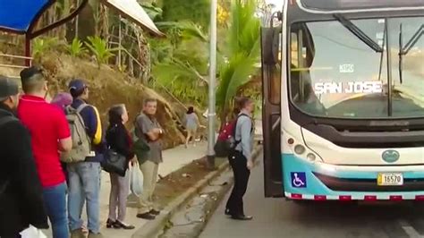 Mujeres esperando en una parada de autobús en hora pico en una ciudad latinoamericana