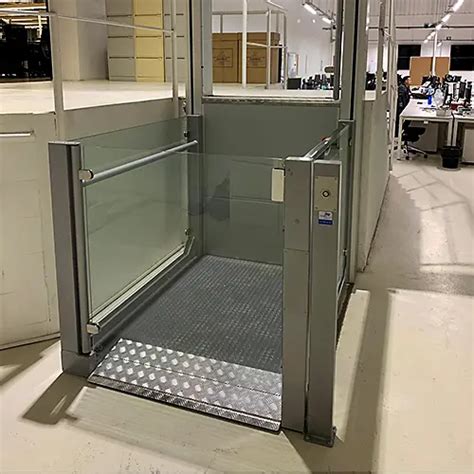 Esquema de un elevador de plataforma vertical para sillas de ruedas mostrando sus componentes de seguridad