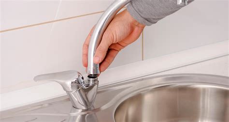 Fotografía de un brazo bajo el grifo de agua fría para quemaduras