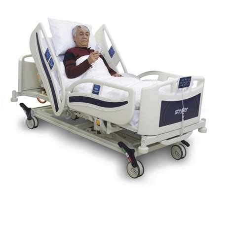 Foto de una cama de hospital con barandillas ajustables subidas